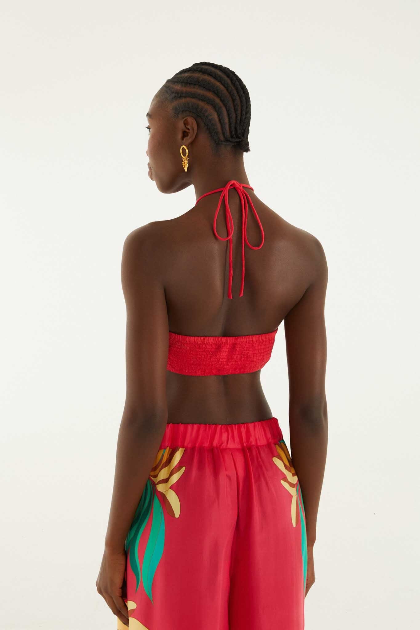 FARM Rio model wearing the Red 3d Shell Halter Neck Crop Top