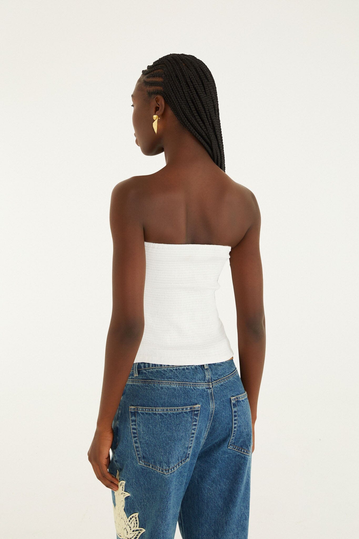 FARM Rio model wearing the White Smocked Strapless Top