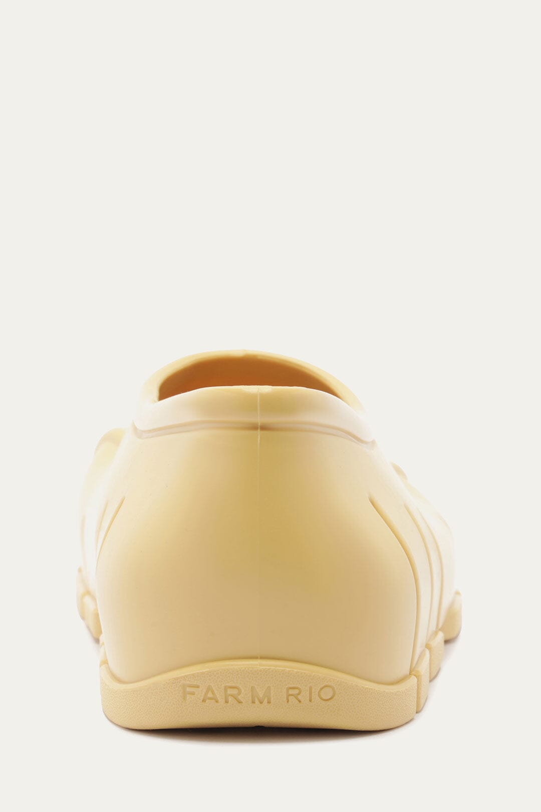 FARM Rio model wearing the Butter Yellow Monstera Rain Shoe