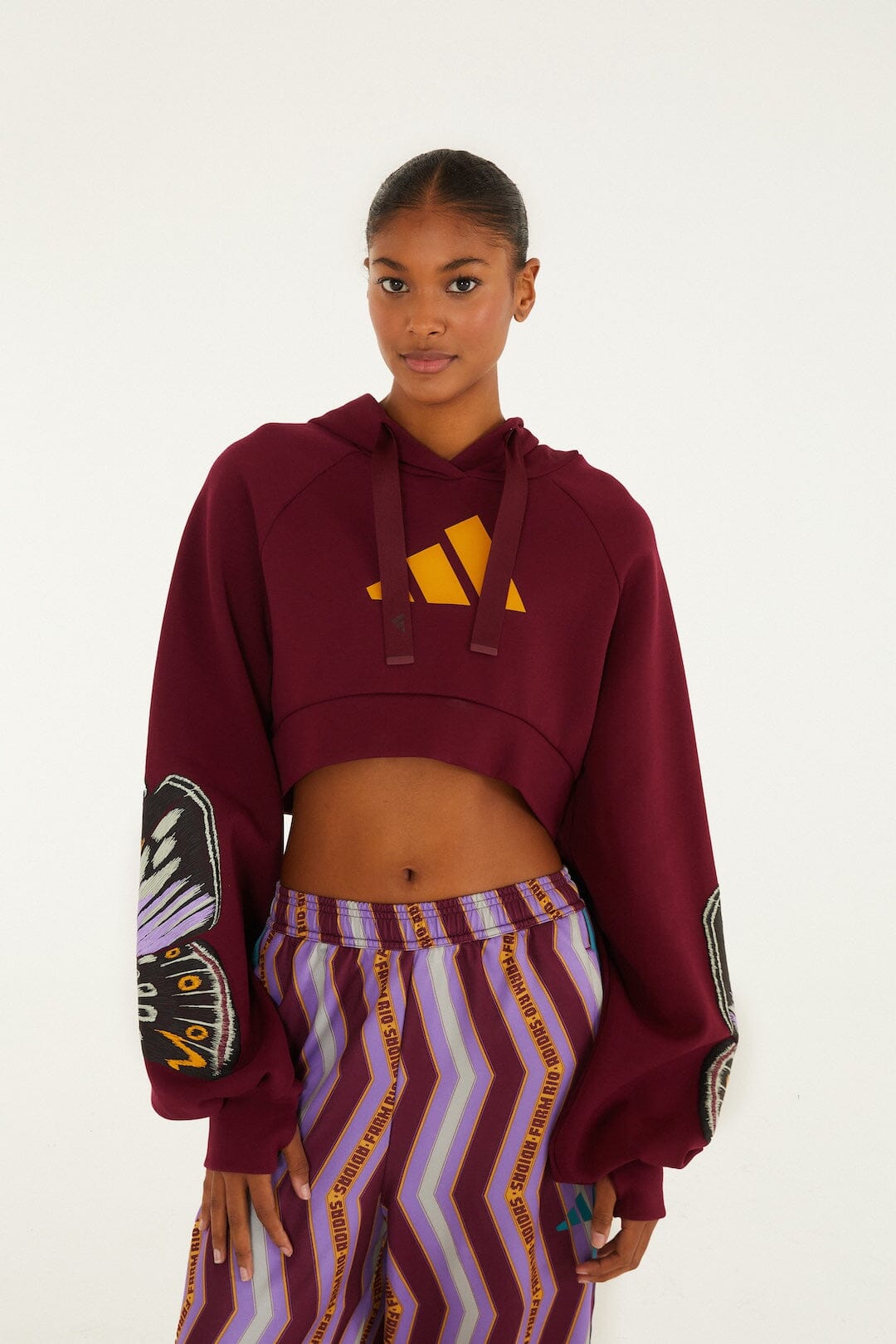 FARM Rio model wearing the Colorfly Adidas Amazon Red Hoodie