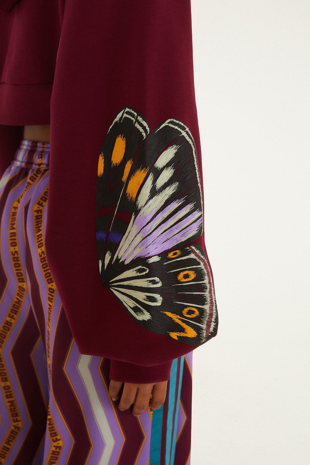 FARM Rio model wearing the Colorfly Adidas Amazon Red Hoodie