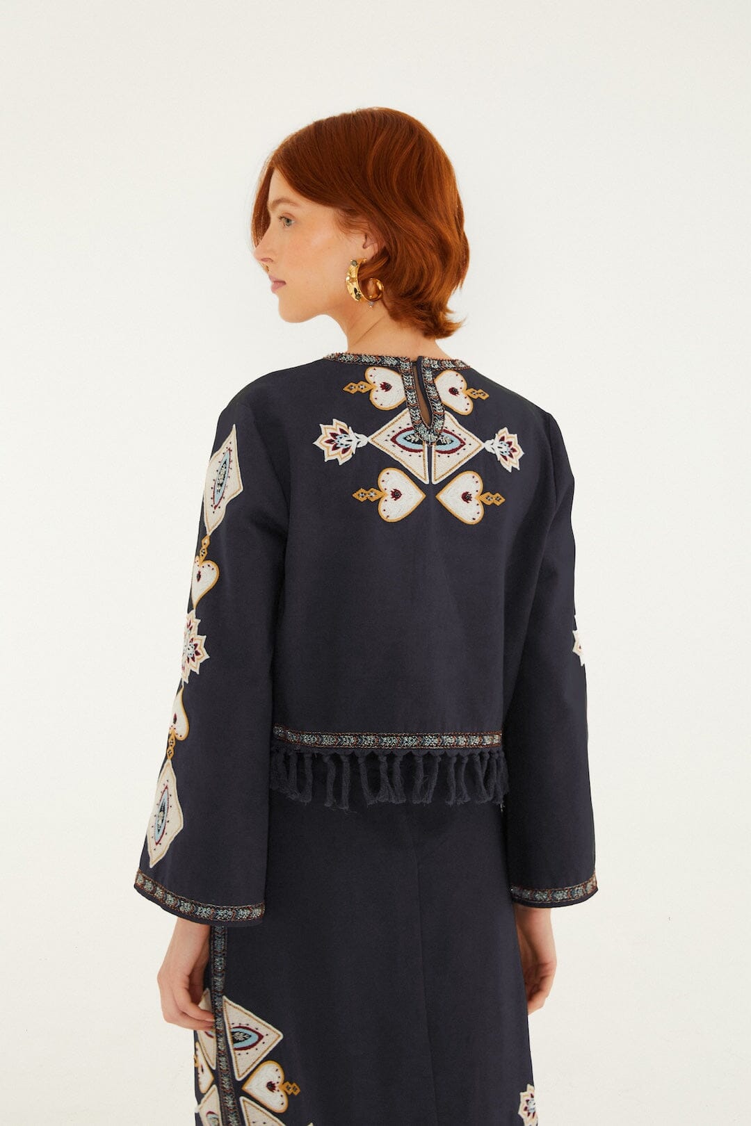 FARM Rio model wearing the Embroidered Long Sleeve Fringe Crop Top