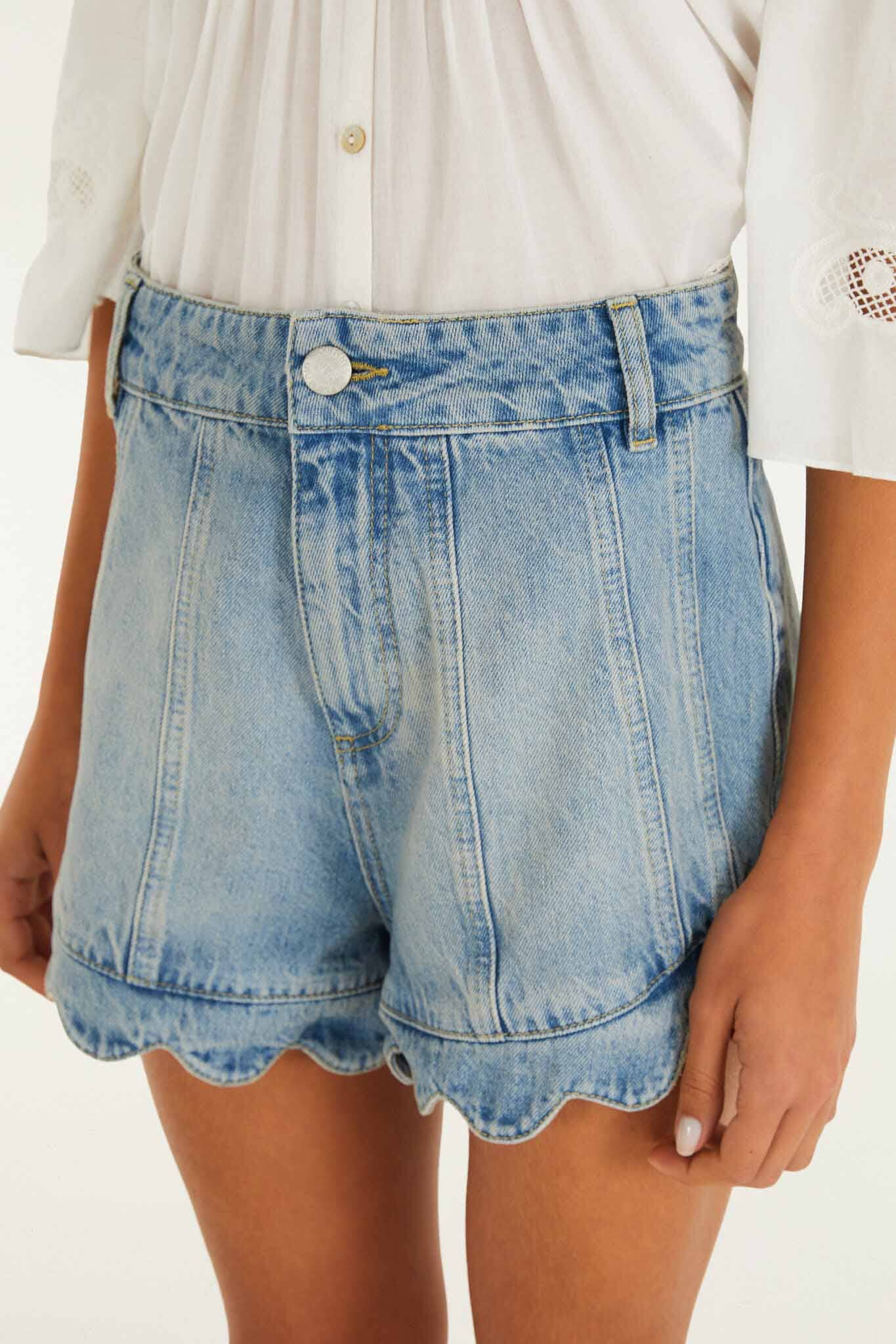 FARM Rio model wearing the Light Denim Romantic Wavy Hem Shorts