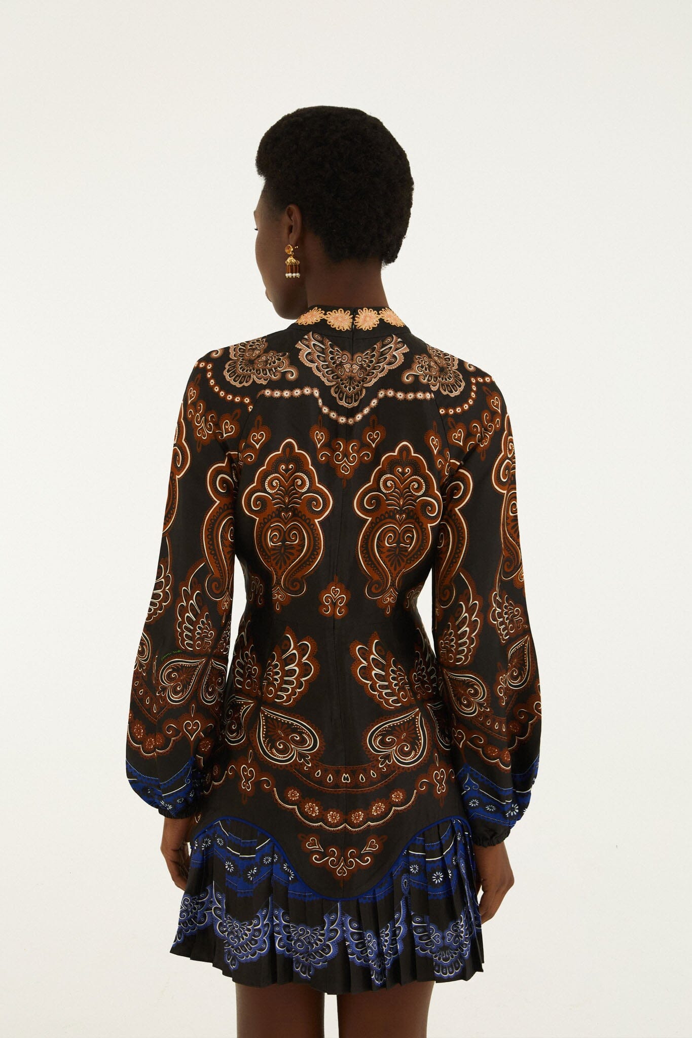 FARM Rio model wearing the Nicole Ruffled Long Sleeve Mini Dress