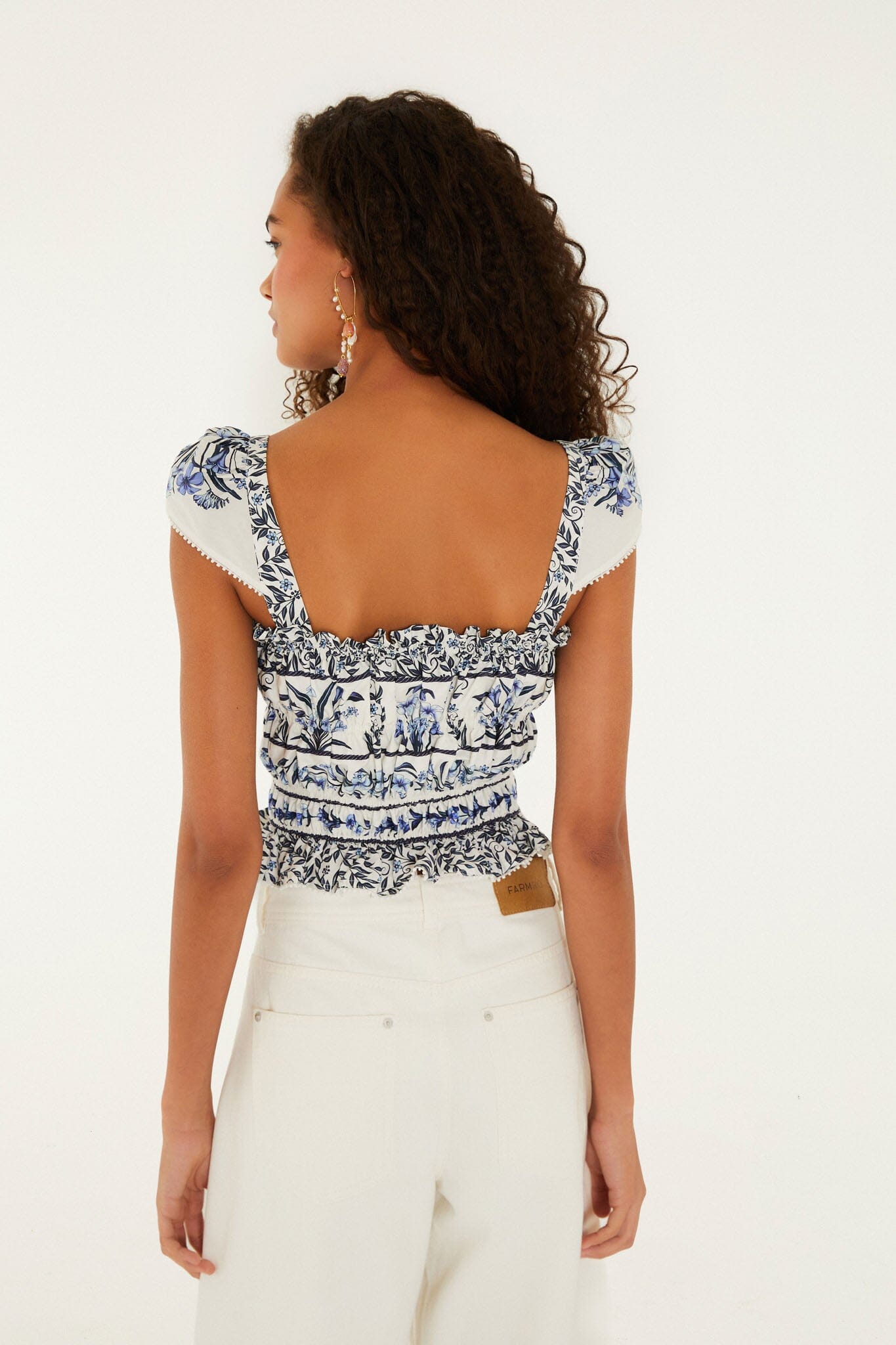 FARM Rio model wearing the Off-White Flowers Arch Smocked Organic Cotton Blouse