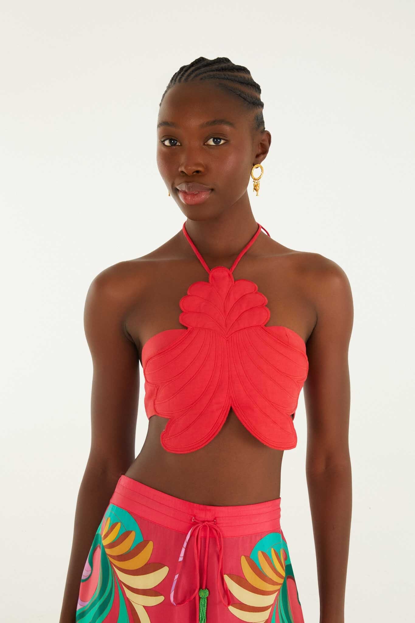 FARM Rio model wearing the Red 3d Shell Halter Neck Crop Top