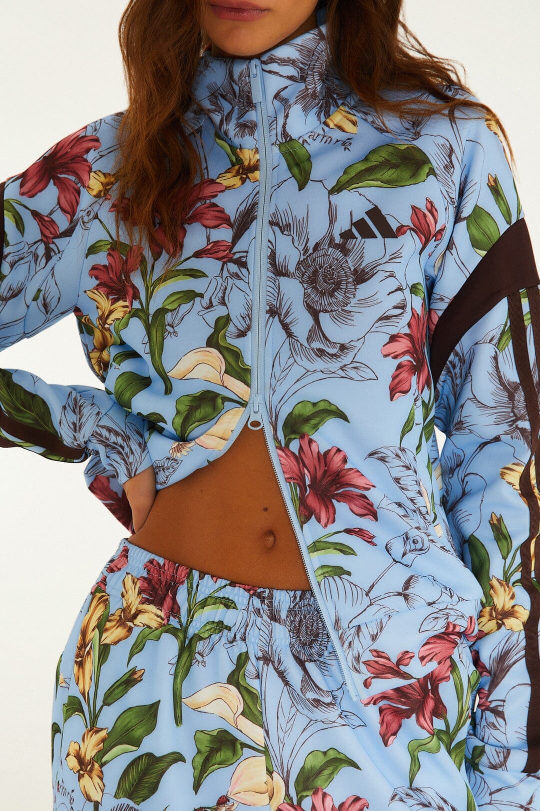 FARM Rio model wearing the Sketch Floral Blue Adidas Tiro Jacket