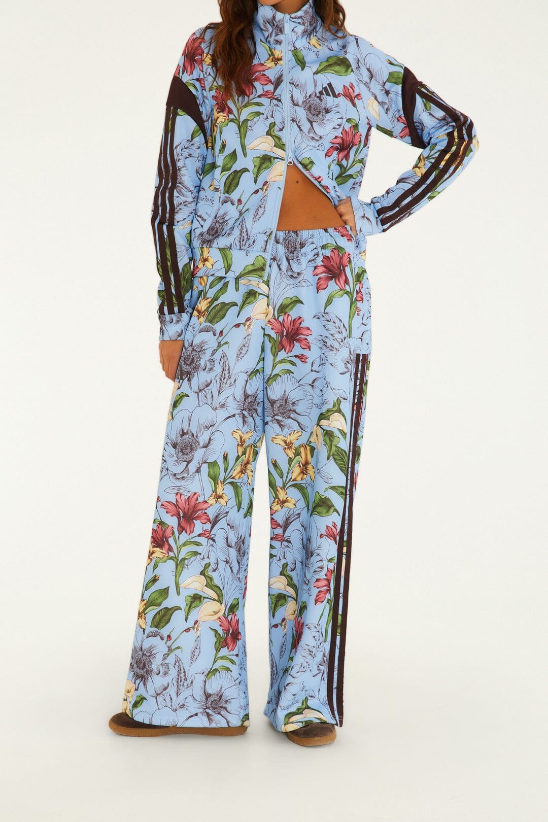 FARM Rio model wearing the Sketch Floral Blue Adidas Tiro Pants