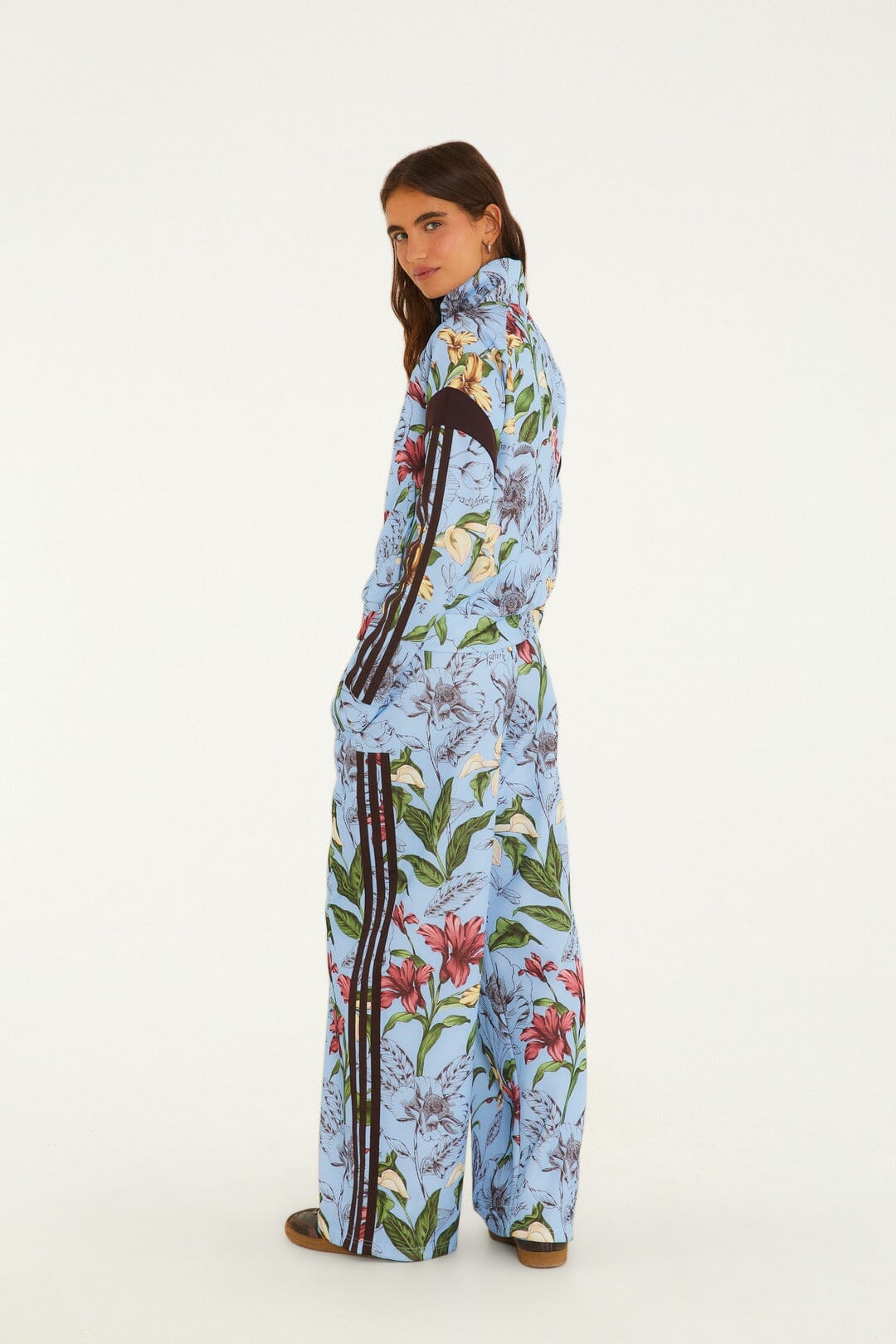 FARM Rio model wearing the Sketch Floral Blue Adidas Tiro Pants