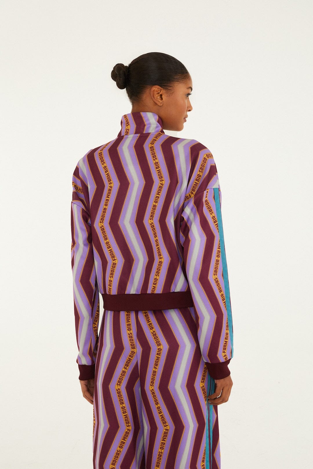 FARM Rio model wearing the Zig Zag Stripes Lilac Adidas Tiro Jacket